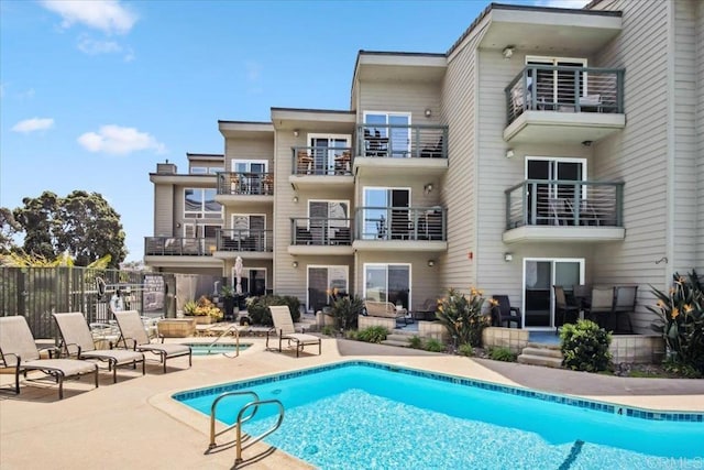 view of swimming pool with a fenced in pool, fence, and a patio