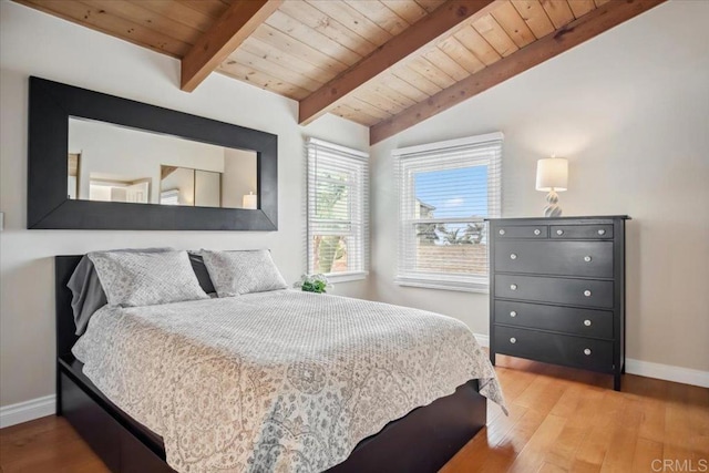 bedroom with wooden ceiling, baseboards, lofted ceiling with beams, and wood finished floors