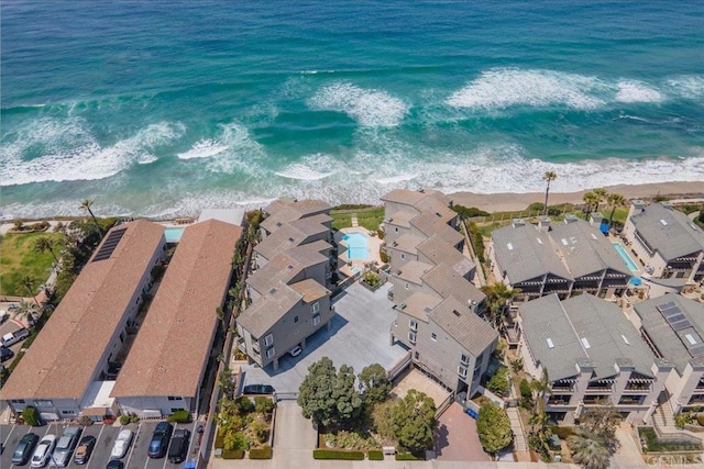 aerial view featuring a beach view, a residential view, and a water view