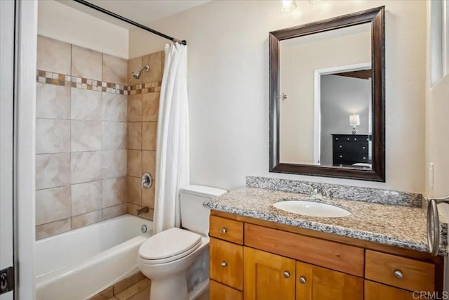 bathroom with vanity, shower / bath combo, and toilet