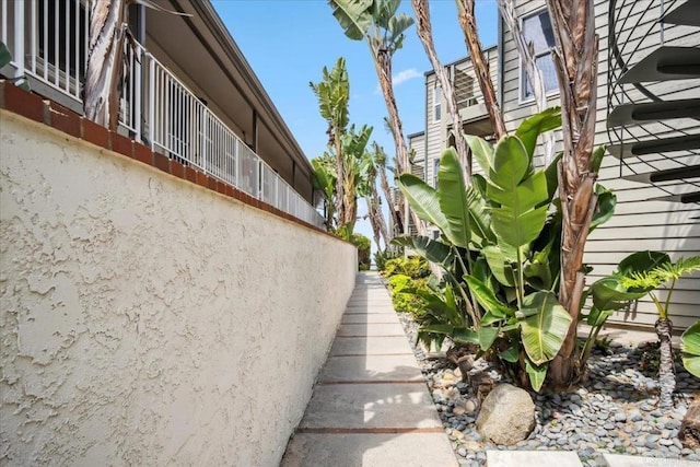 view of home's exterior featuring stairs and stucco siding