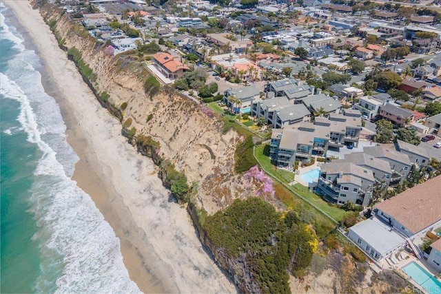 bird's eye view featuring a view of the beach, a residential view, and a water view