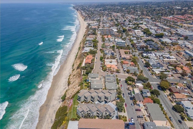 drone / aerial view with a water view and a beach view