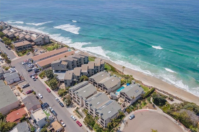 birds eye view of property featuring a beach view, a residential view, and a water view