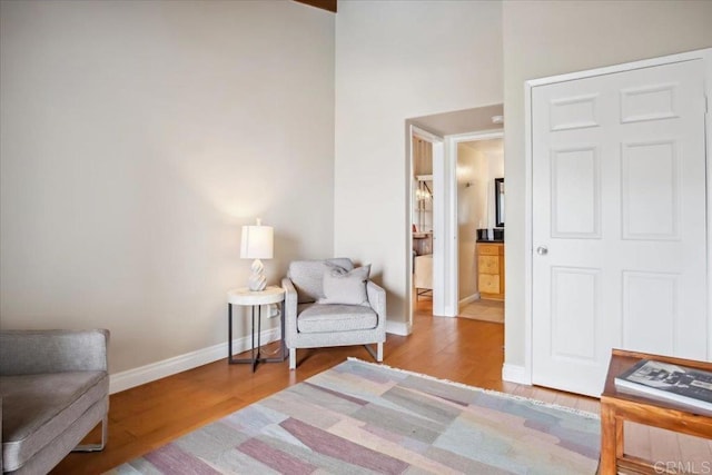 living area featuring baseboards and wood finished floors