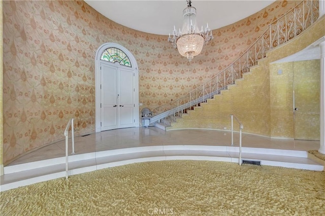 4300 Parkview Dr, Lakewood, CA 90712 - foyer featuring visible vents, wallpapered walls, a chandelier, and stairway