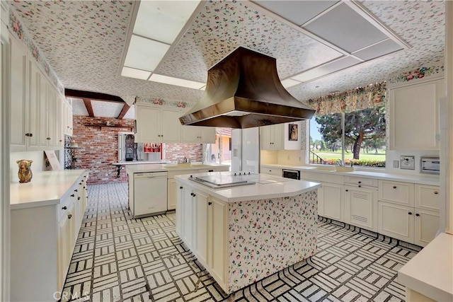 4300 Parkview Dr, Lakewood, CA 90712 - kitchen featuring island exhaust hood, dishwasher, light countertops, brick patterned floor, and electric cooktop