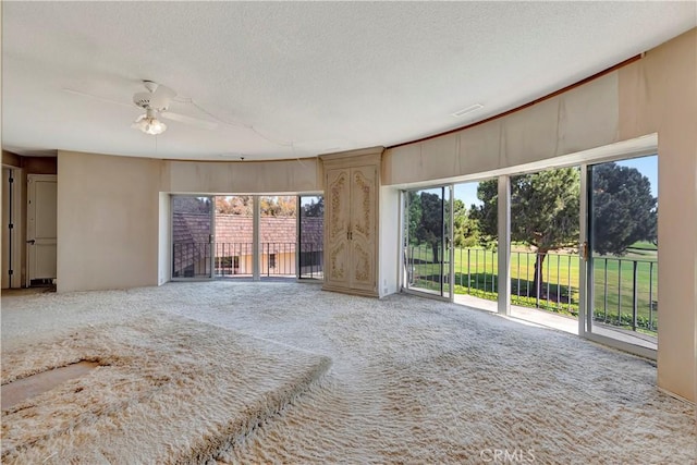 4300 Parkview Dr, Lakewood, CA 90712 - unfurnished living room with a healthy amount of sunlight, carpet, a ceiling fan, and a textured ceiling
