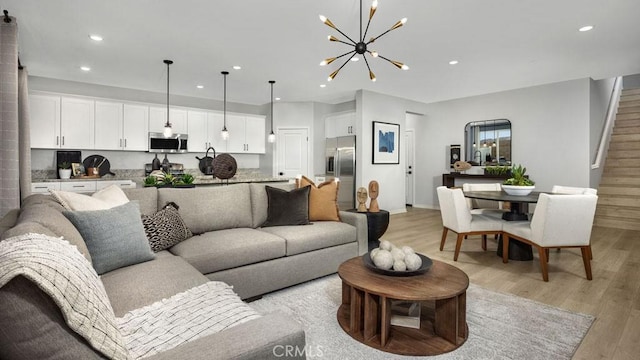 32798 Crystal Cove Ct, Winchester, CA 92596 - living room with light wood-style floors, recessed lighting, baseboards, and a notable chandelier