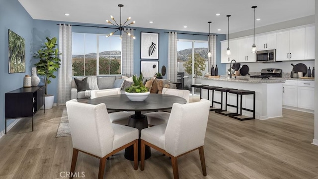 32798 Crystal Cove Ct, Winchester, CA 92596 - dining area featuring recessed lighting, light wood finished floors, a mountain view, and a notable chandelier