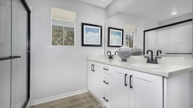 32798 Crystal Cove Ct, Winchester, CA 92596 - bathroom featuring a sink, baseboards, a stall shower, and wood finished floors
