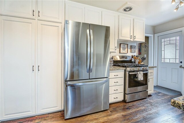 3871 San Mateo Ave, Riverside, CA 92504 - kitchen with dark wood-style flooring, white cabinetry, appliances with stainless steel finishes, and light stone countertops
