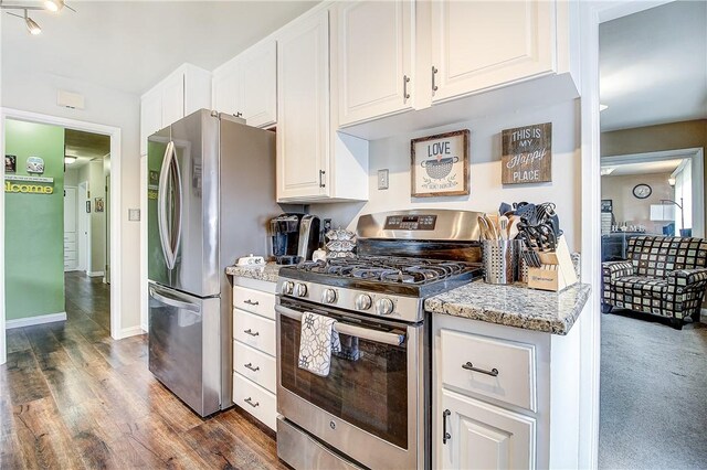 3871 San Mateo Ave, Riverside, CA 92504 - kitchen featuring appliances with stainless steel finishes, wood finished floors, light stone counters, white cabinets, and baseboards