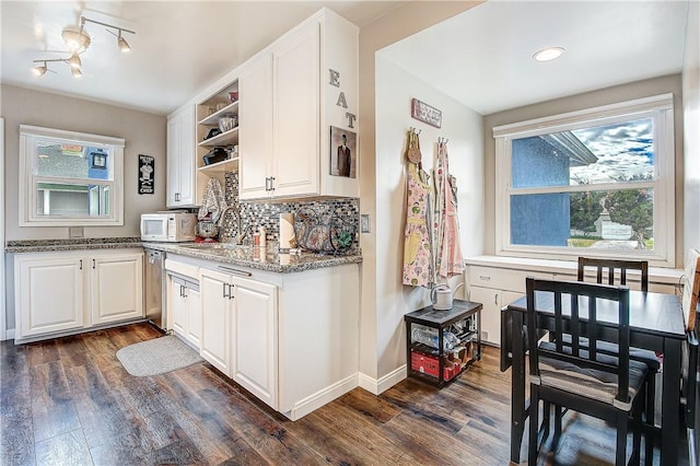 3871 San Mateo Ave, Riverside, CA 92504 - kitchen featuring stainless steel dishwasher, open shelves, dark wood-style flooring, white microwave, and light stone counters
