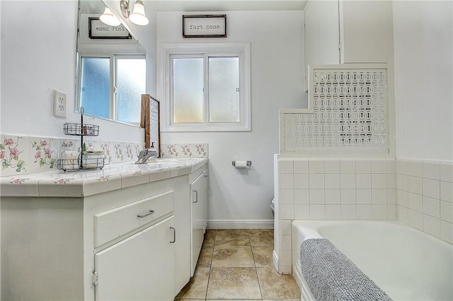 3871 San Mateo Ave, Riverside, CA 92504 - bathroom with toilet, baseboards, a bath, and vanity