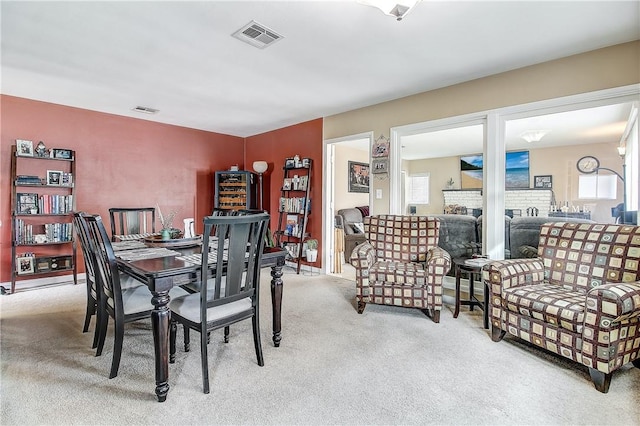 3871 San Mateo Ave, Riverside, CA 92504 - carpeted dining area with a brick fireplace and visible vents