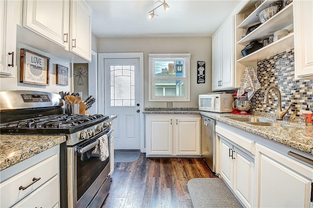 3871 San Mateo Ave, Riverside, CA 92504 - kitchen with backsplash, appliances with stainless steel finishes, open shelves, a sink, and dark wood-style floors