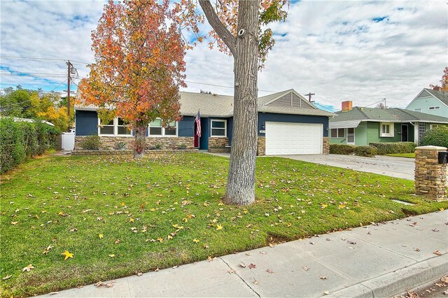 3871 San Mateo Ave, Riverside, CA 92504 - view of front facade with an attached garage, concrete driveway, a front lawn, and stone siding