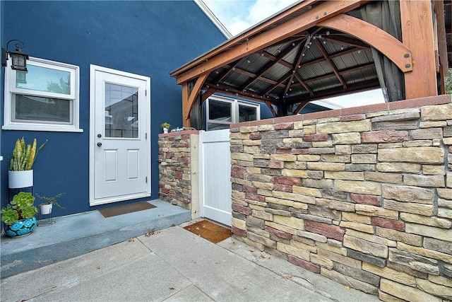 3871 San Mateo Ave, Riverside, CA 92504 - doorway to property featuring stucco siding and stone siding