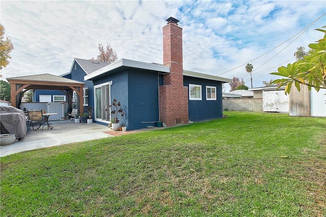 3871 San Mateo Ave, Riverside, CA 92504 - rear view of property featuring stucco siding, a chimney, a patio area, a gazebo, and a yard