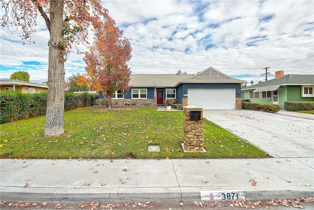 3871 San Mateo Ave, Riverside, CA 92504 - single story home with an attached garage, driveway, stone siding, and a front lawn