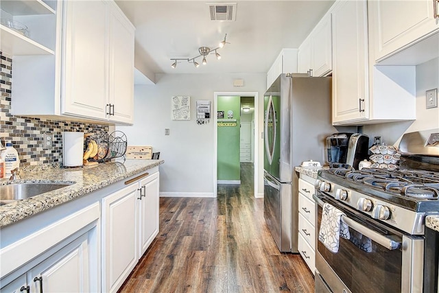 3871 San Mateo Ave, Riverside, CA 92504 - kitchen featuring decorative backsplash, dark wood-style flooring, visible vents, appliances with stainless steel finishes, and white cabinetry