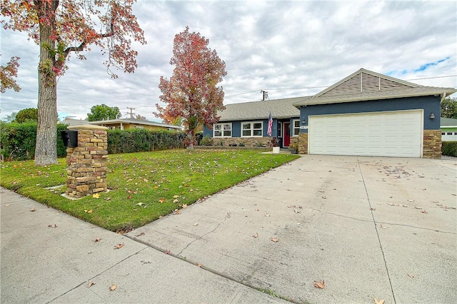 3871 San Mateo Ave, Riverside, CA 92504 - ranch-style home featuring concrete driveway, a front lawn, stone siding, and a garage