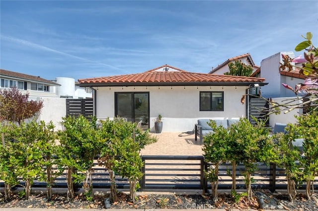 back of house with a patio, fence, a tile roof, and stucco siding