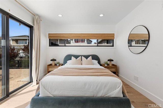 bedroom with baseboards, recessed lighting, wood finished floors, and access to exterior