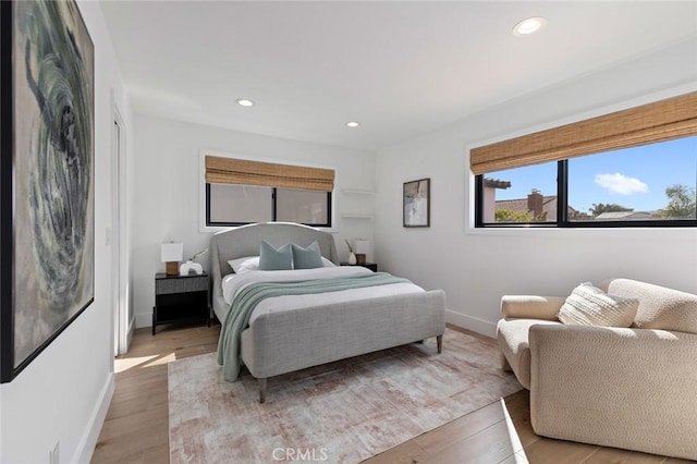 bedroom featuring baseboards, recessed lighting, and light wood-type flooring
