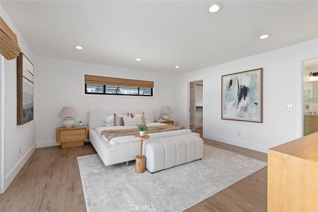 317 Via Lido Nord, Newport Beach, CA 92663 - bedroom with light wood finished floors, a walk in closet, recessed lighting, and baseboards