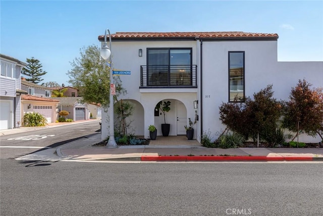 317 Via Lido Nord, Newport Beach, CA 92663 - view of front facade featuring stucco siding, a balcony, and a tiled roof
