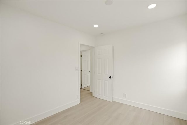 unfurnished room featuring baseboards, recessed lighting, and light wood-style flooring
