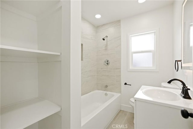 full bath featuring vanity, tub / shower combination, wood finished floors, toilet, and recessed lighting
