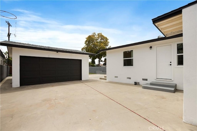 view of side of home with an outdoor structure, stucco siding, crawl space, and entry steps