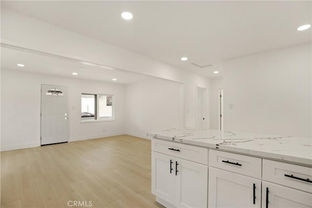 kitchen featuring light stone countertops, baseboards, light wood-type flooring, recessed lighting, and white cabinets