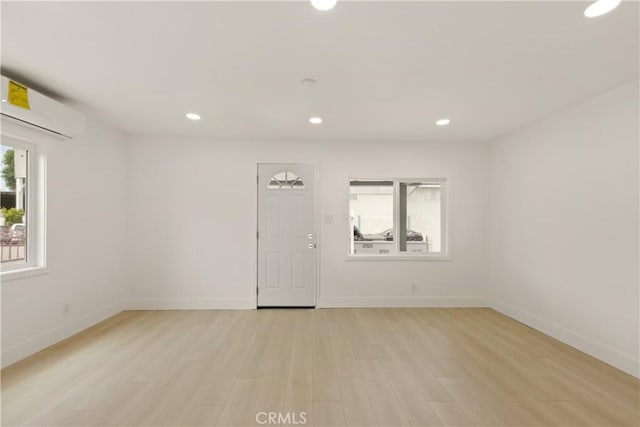 unfurnished room with light wood-style floors, recessed lighting, and baseboards