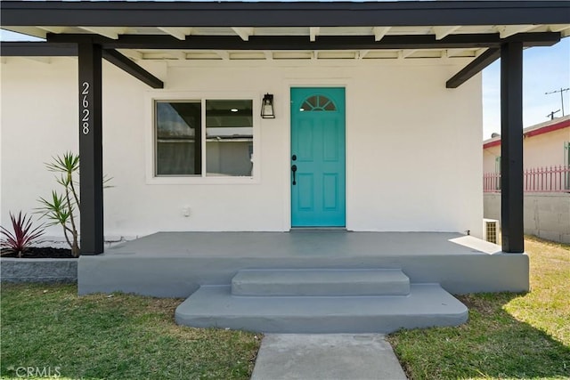 doorway to property featuring stucco siding