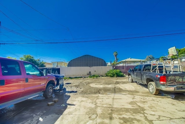 view of car parking featuring fence
