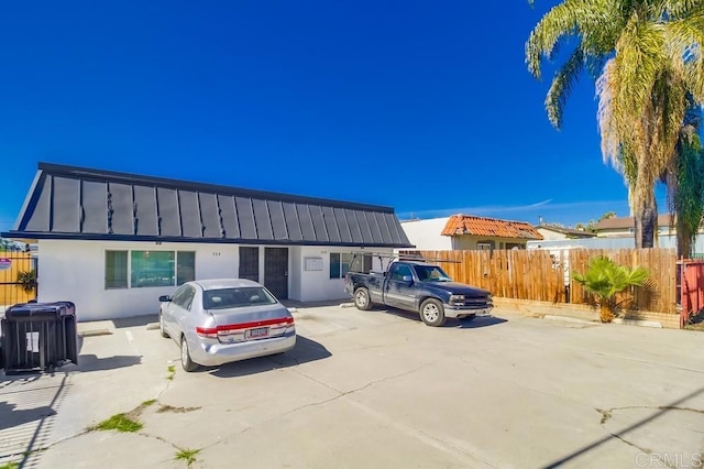 view of front of home with stucco siding and fence