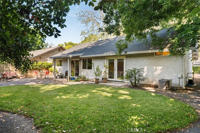 ranch-style home with a front lawn, fence, a patio, stucco siding, and french doors