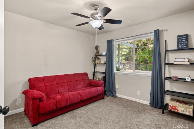 living room featuring carpet floors, a ceiling fan, and baseboards