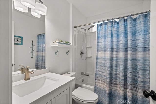 bathroom with vanity, shower / bath combo with shower curtain, and toilet