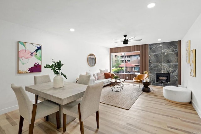 dining room featuring baseboards, recessed lighting, ceiling fan, and light wood-type flooring