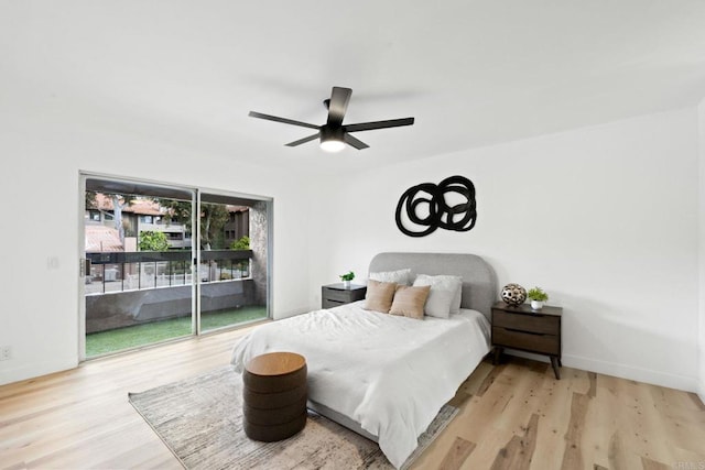 bedroom with baseboards, wood finished floors, and access to exterior