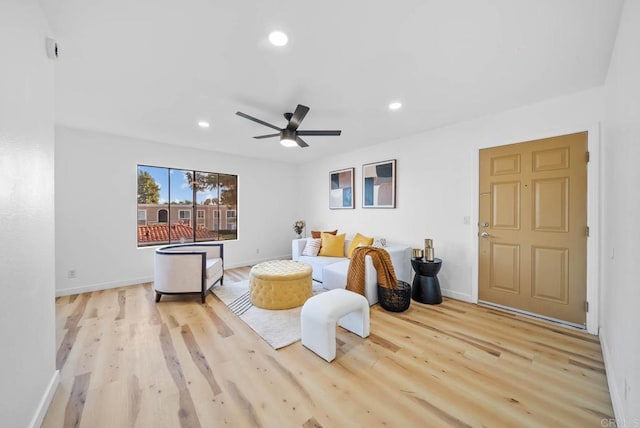 living area with baseboards, ceiling fan, recessed lighting, and wood finished floors