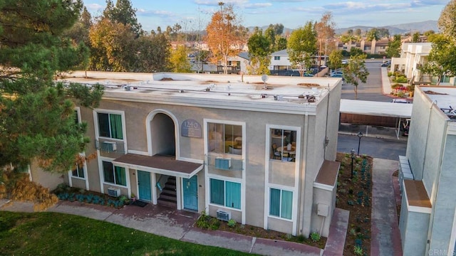 exterior space with stucco siding and a residential view