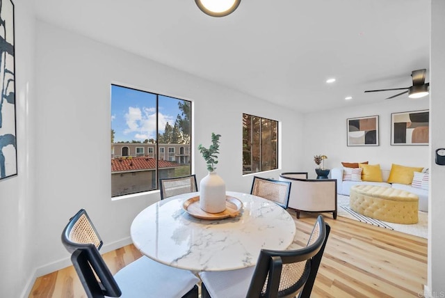dining room featuring light wood-style floors, baseboards, ceiling fan, and recessed lighting