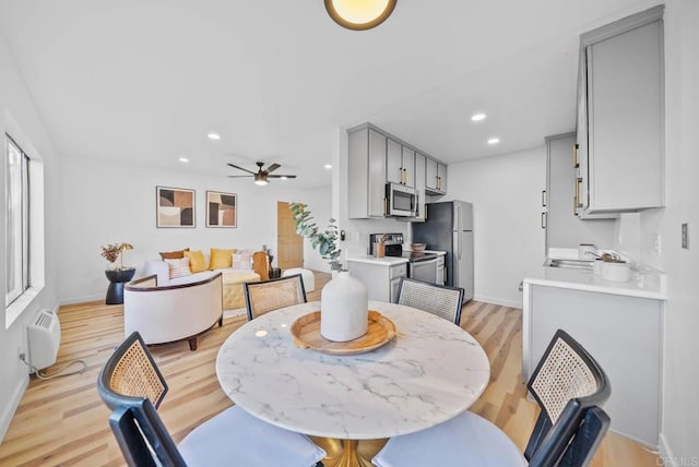 dining area featuring recessed lighting, light wood-style flooring, ceiling fan, and baseboards