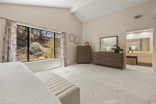 carpeted bedroom with visible vents, ensuite bathroom, high vaulted ceiling, and beamed ceiling